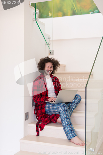 Image of freelancer in bathrobe working from home