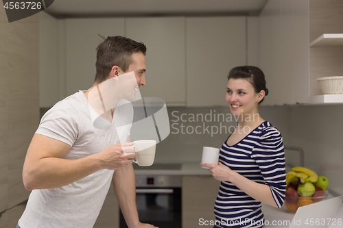 Image of couple with laptop computer enjoying morning