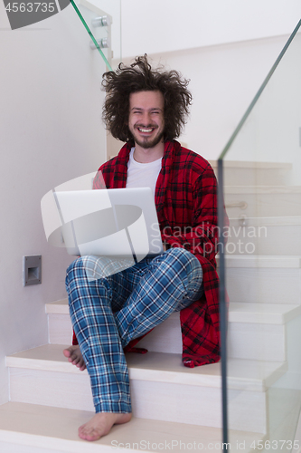 Image of freelancer in bathrobe working from home