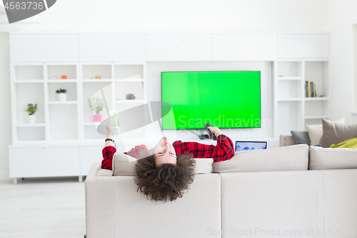 Image of young man in bathrobe enjoying free time