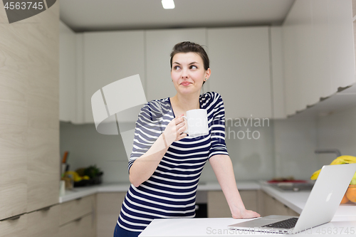 Image of woman drinking coffee enjoying relaxing lifestyle