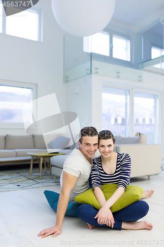Image of couple sitting on the floor at home