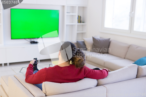 Image of Young couple on the sofa watching television