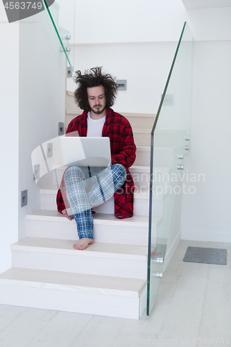 Image of freelancer in bathrobe working from home