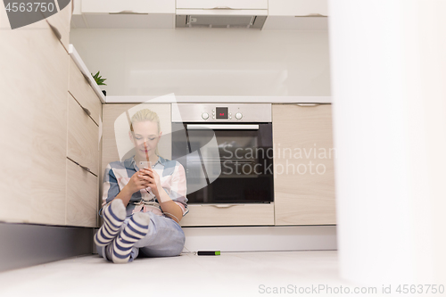 Image of young women using mobile phone at home