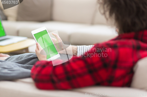 Image of couple relaxing at  home with tablet computers