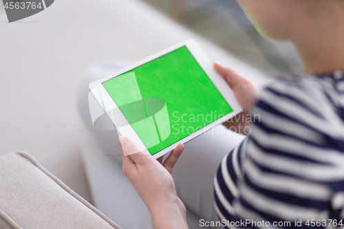 Image of woman on sofa using tablet computer