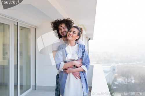 Image of Couple hugging on the balcony