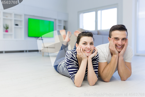 Image of couple lying on the floor at home
