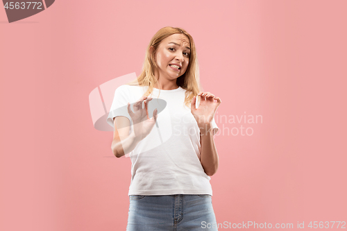 Image of Let me think. Doubtful pensive woman with thoughtful expression making choice against pink background