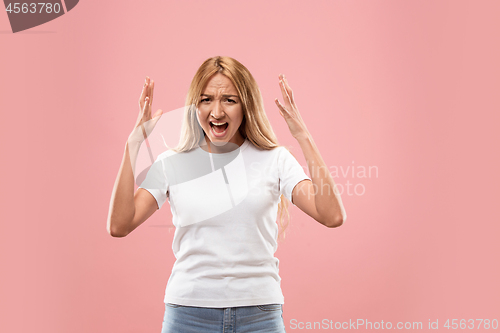 Image of The young emotional angry woman screaming on studio background