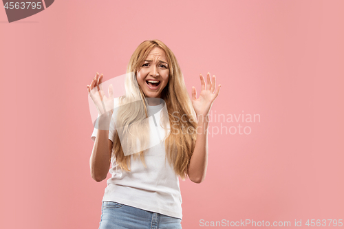 Image of Portrait of the scared woman on pink