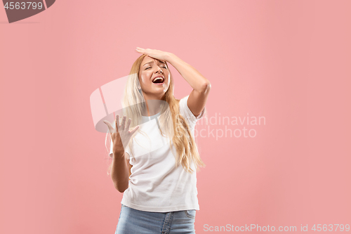 Image of Beautiful woman looking suprised and bewildered isolated on pink