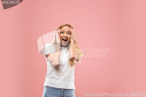 Image of Portrait of the scared woman on pink