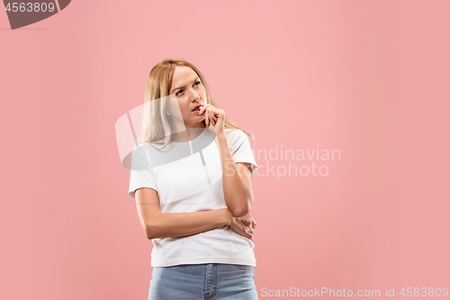 Image of Young serious thoughtful business woman. Doubt concept.