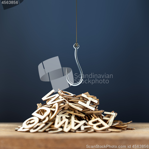 Image of pile of wooden letters with a hook