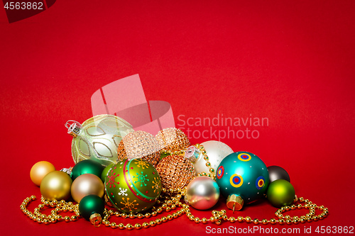 Image of Christmas decoration glass balls on red background