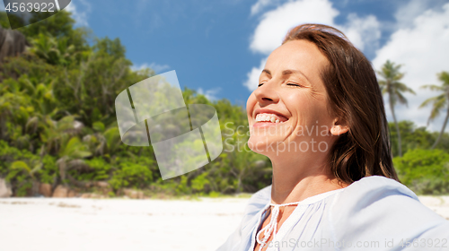 Image of happy woman over seychelles island tropical beach