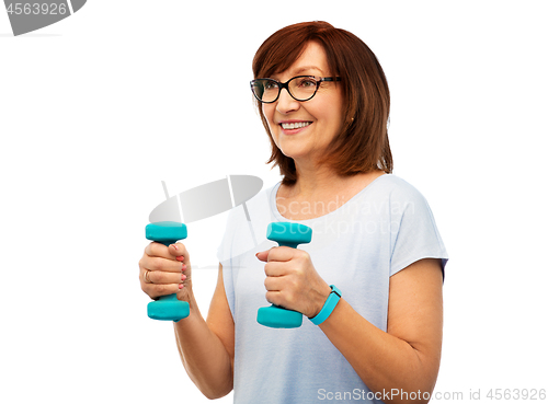 Image of smiling senior woman with dumbbells exercising