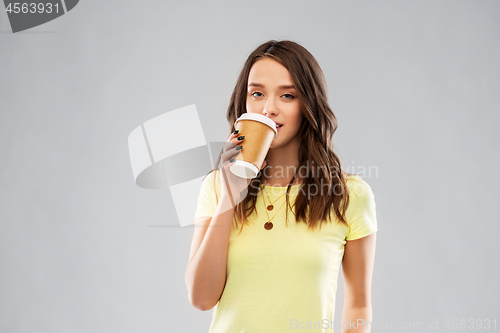 Image of young woman or teenage girl drinking coffee