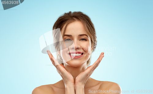 Image of smiling young woman over blue background