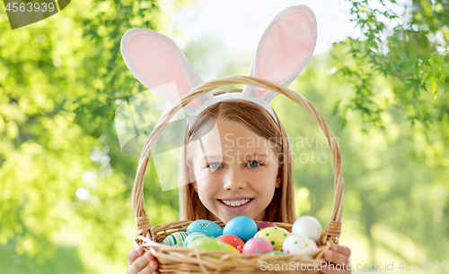 Image of happy girl with colored easter eggs