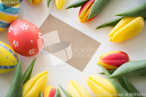 Image of close up of colored easter eggs and tulip flowers