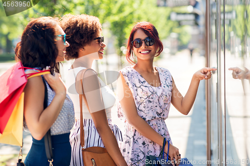 Image of women with shopping bags looking at shop window