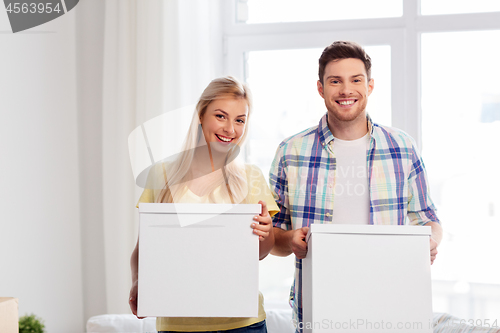 Image of happy couple with boxes moving to new home