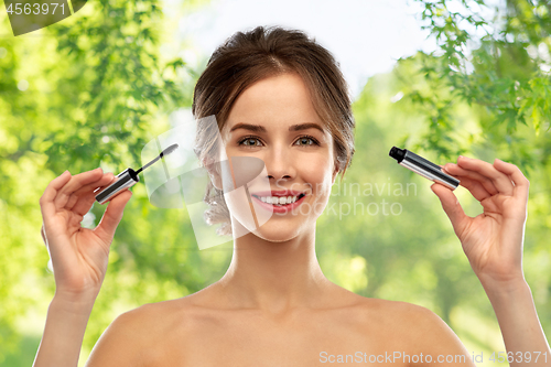 Image of woman with mascara applying make up