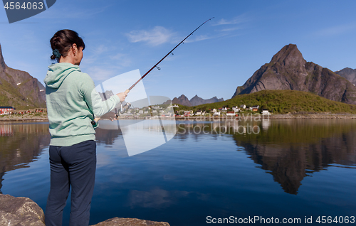 Image of Woman fishing on Fishing rod spinning in Norway.