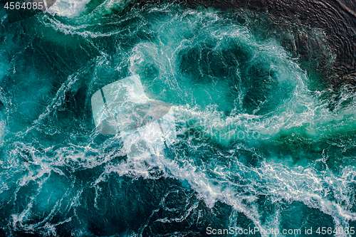 Image of Waves of water of the river and the sea meet each other during h