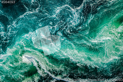 Image of Waves of water of the river and the sea meet each other during h