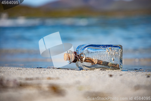 Image of Message in the bottle against the Sun setting down