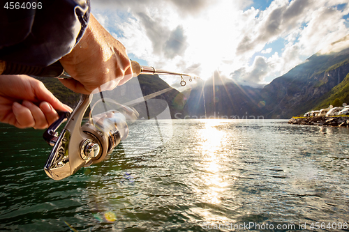 Image of Woman fishing on Fishing rod spinning in Norway.