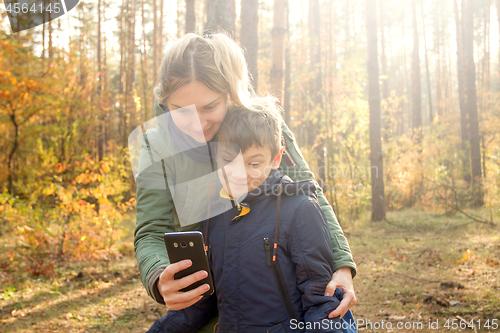 Image of Son and Mother are making selfie in the Park