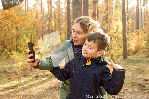 Image of Son and Mother are making selfie in the Park