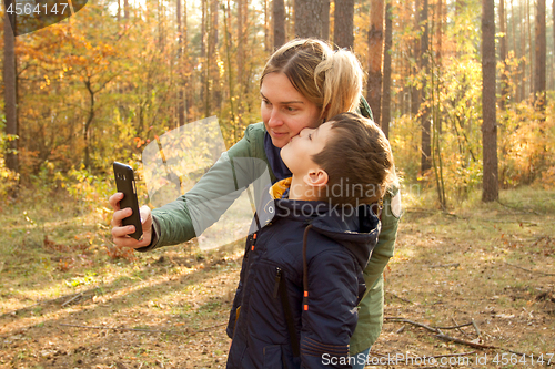 Image of Son and Mother are making selfie in the Park