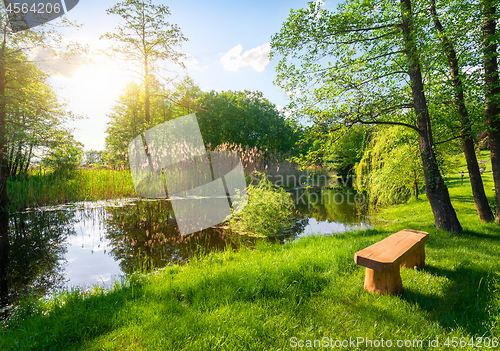 Image of Wooden bench near river