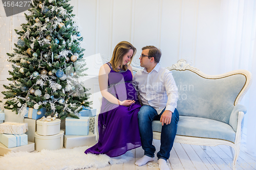 Image of Family portrait near christmas tree