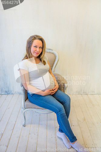 Image of Beautiful pregnant woman sitting