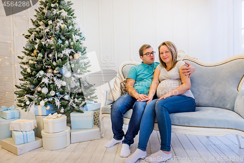 Image of Family portrait near christmas tree