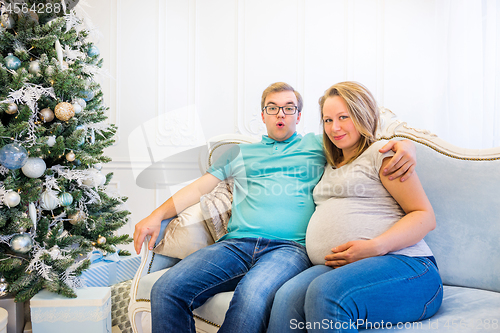 Image of Family portrait near christmas tree