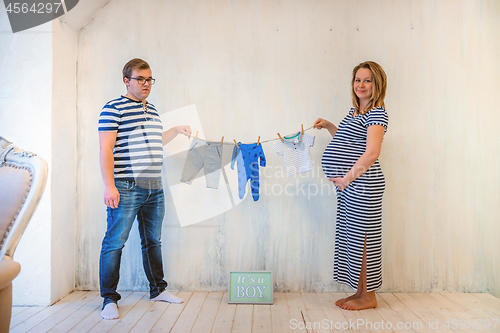 Image of Young couple: pregnant woman and man