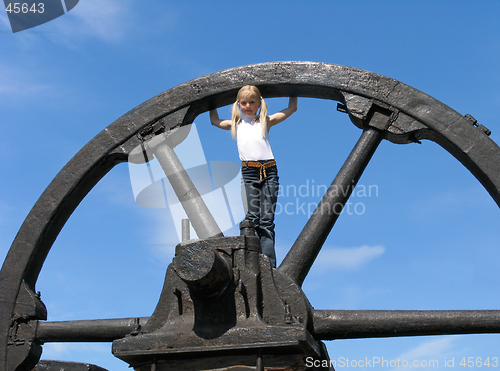Image of Little girl and large wheel