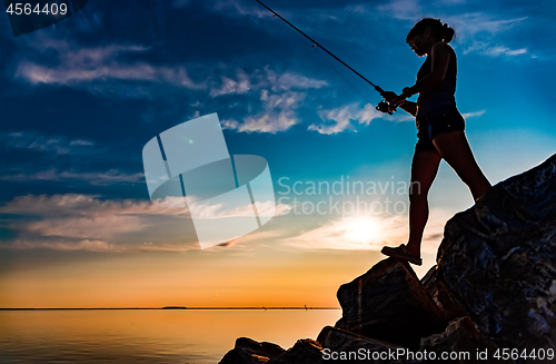 Image of Woman fishing on Fishing rod spinning in Norway.