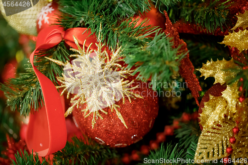 Image of Red Christmas ball hanging on Christmas tree.