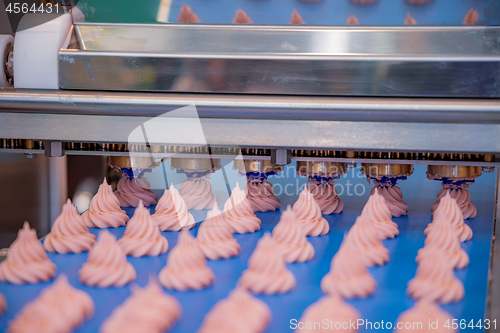 Image of Cakes on automatic conveyor belt , process of baking in confecti