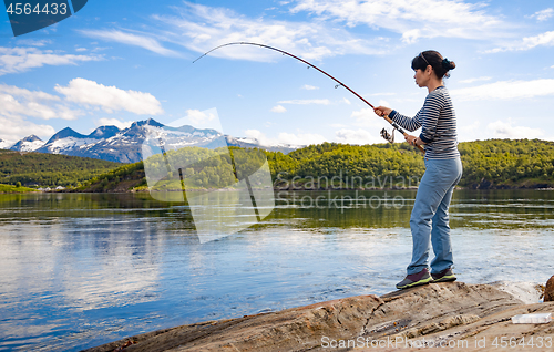 Image of Woman fishing on Fishing rod spinning in Norway.