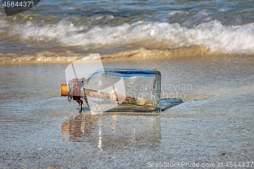 Image of Message in the bottle against the Sun setting down